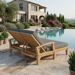 Anderson Teak Brianna double sun lounger in A-grade teak wood with a modern design, shown in a garden outdoor setting.