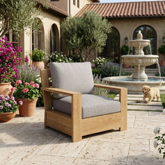 Anderson Teak teak wood deep seating accent armchair with plush cushions, shown in a designer color for outdoor patio or garden.