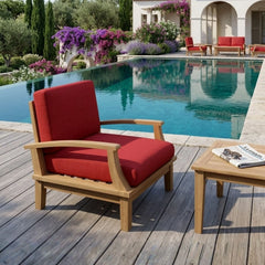 Anderson Teak Brianna deep seating outdoor armchair with plush cushions in a garden setting, available in nine designer colors.