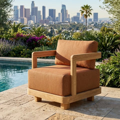 Anderson Teak Granada deep seating armchair in outdoor patio setting, showcasing plush cushions and available in 9 designer colors.