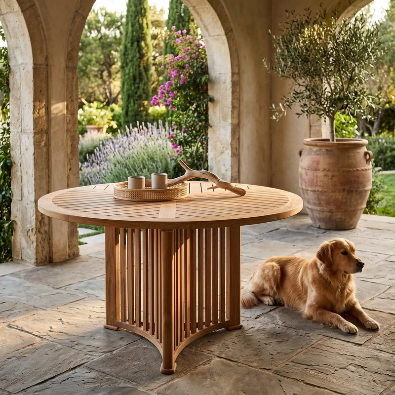 Round teak table by Anderson Teak with smooth wooden surface and sturdy legs, suitable for outdoor or patio dining.
