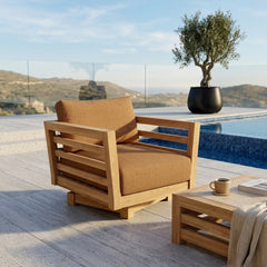 Anderson Teak Cordoba deep seating swivel armchair with cushion in a garden setting, available in 9 designer colors.