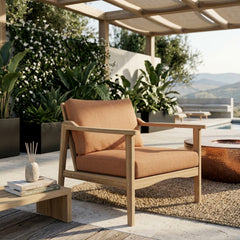 Anderson Teak Amalfi deep seating armchair in outdoor patio setting, showing plush cushions and vibrant designer color options.