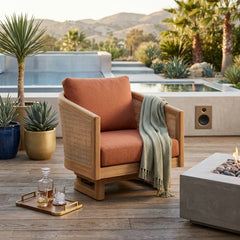 Anderson Teak Catania swivel chair in teak wood with a deep seat, outdoor design, shown in a natural outdoor patio setting.