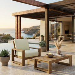 Anderson Teak Capistrano deep seating accent armchair in outdoor patio setting, showing sleek design and vibrant fabric colors.