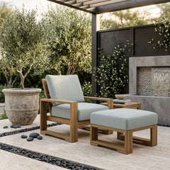 Anderson Teak Capistrano deep seating set with one armchair and table in a garden outdoor patio, available in nine designer colors.