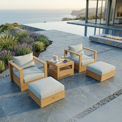 Set of two teak wood outdoor armchairs and two ottomans from Anderson Teak in natural wood finish for garden lounge seating.