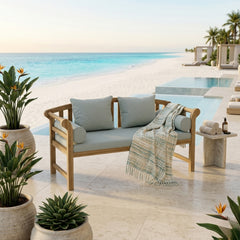 Anderson Teak Brisbane deep seating outdoor sofa with plush cushions in a luxurious garden setting, available in nine designer colors.
