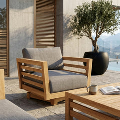 Anderson Teak Cordoba deep seating swivel armchair with colorful cushions, outdoor patio furniture for garden relaxation.