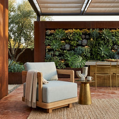 Anderson Teak Granada Swivel Armchair in outdoor patio setting, available in 9 designer colors, deep seating for garden and patio.