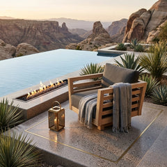 Anderson Teak Cordoba deep seating swivel armchair with plush cushions, outdoor patio seating in a natural garden setting.