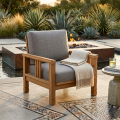 Southbay teak wood deep seating accent armchair by Anderson Teak, shown in a natural outdoor patio setting with designer color options.
