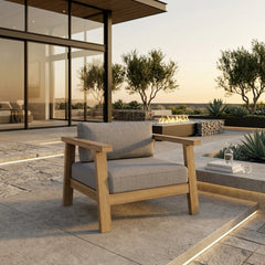 Anderson Teak Palermo teak wood deep seating accent armchair with plush cushions in outdoor patio setting, available in nine designer colors.