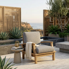Anderson Teak Brianna deep seating armchair in a stylish outdoor patio setting, showcasing its plush cushions and designer color options.