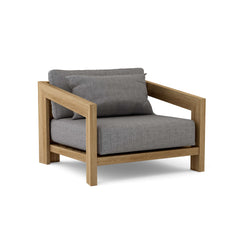 Anderson Teak Smyrna Lounge Armchair in cast pomegranate, outdoor teak accent chair with deep seating for patio or garden.