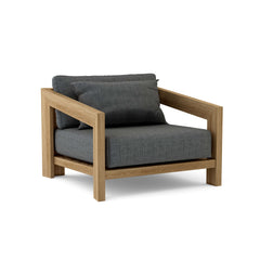 Anderson Teak Smyrna Lounge Armchair in cast pomegranate, outdoor teak wood accent chair with deep seating and nine designer color options.