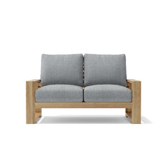 Anderson Teak Capistrano deep seating loveseat with plush cushions in nine designer colors, perfect for outdoor relaxation.