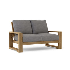 Anderson Teak Capistrano deep seating loveseat in a modern design, available in nine designer colors with plush cushions.