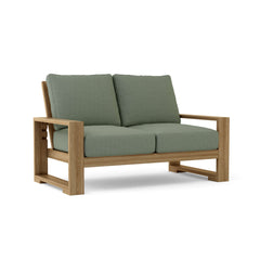 Anderson Teak Capistrano deep seating loveseat for outdoor patio, available in natural canvas and 9 designer colors, perfect for small spaces.