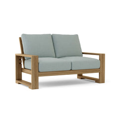 Anderson Teak Capistrano deep seating loveseat in 9 designer colors, showcasing plush cushions and stylish teak frame.
