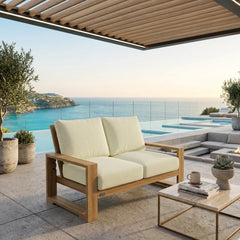Anderson Teak Capistrano deep seating loveseat with plush cushions in nine designer colors, perfect for outdoor lounging.