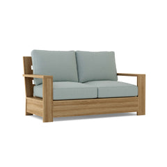 Anderson Teak Madera Deep Seating Loveseat in a designer color, showcasing plush cushions and sleek wooden frame.