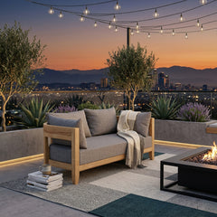 Anderson Teak Coronado Deep Sofa love seat in cast pomegranate, outdoor teak wood, modular design, with cushions in a small patio setting.