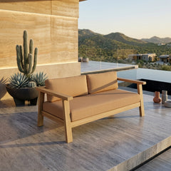 Anderson Teak Palermo deep outdoor patio loveseat in cast pomegranate, made of A-grade teak solid wood, for small elegant outdoor spaces.