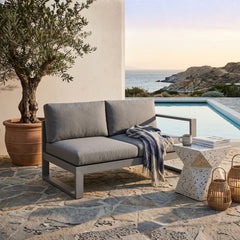 Anderson Teak Lucca left loveseat with teak wood frame and plush cushions, ideal for outdoor or patio seating.