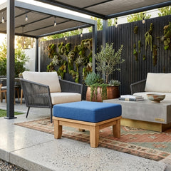 Luxe Anderson Teak ottoman with cushion in nine designer colors, showcasing a modern footstool with plush upholstery.
