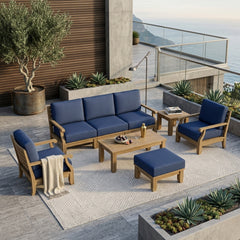 Anderson Teak Riviera Modular Teak Wood Outdoor Sofa set with deep seating, natural canvas cushions, in a garden lounge setting.