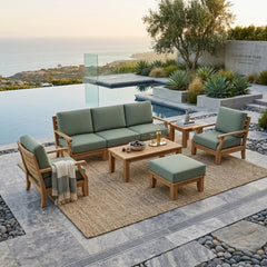 Anderson Teak Riviera Modular Teak Wood Outdoor Sofa set with deep seating, natural canvas cushions, in a garden lounge setting.