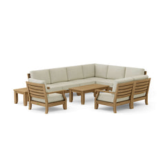 Anderson Teak Riviera Teak Wood Outdoor Sofa set with deep seating, modular design, in a garden lounge setting with colorful cushions.