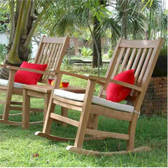 Set of three Anderson Teak Palm Beach rocking chairs in natural wood finish, shown in a stylish outdoor patio setting.