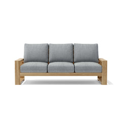 Anderson Teak Capistrano teak wood outdoor sofa set with natural canvas cushions, part of the 9-color designer outdoor patio collection.