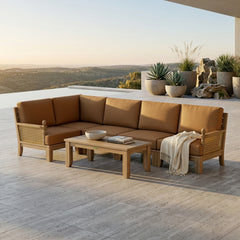 Anderson Teak Luxe Teak Wood Outdoor Sofa with natural canvas cushions, sectional design, in a garden lounge setting.