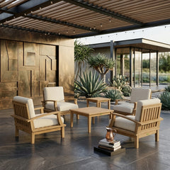 Anderson Teak Brianna teak wood outdoor deep seating set with 4 armchairs and 2 tables in a garden patio setting.