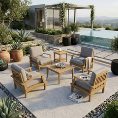 Set of four Anderson Teak Brianna teak wood armchairs with cushions and two matching tables for outdoor patio garden lounge.