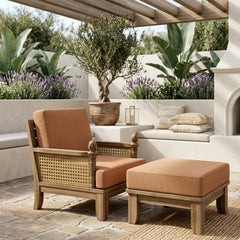 Anderson Teak Luxe Teak Wood Deep Seating Set with one armchair and ottoman in a garden outdoor patio setting.