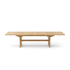 Anderson Teak Sahara 126-inch rectangular double extension table showcasing a teak wood finish and sturdy design.