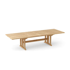 Sahara 126-inch rectangular double extension teak table by Anderson Teak with a smooth wooden surface and sturdy legs.
