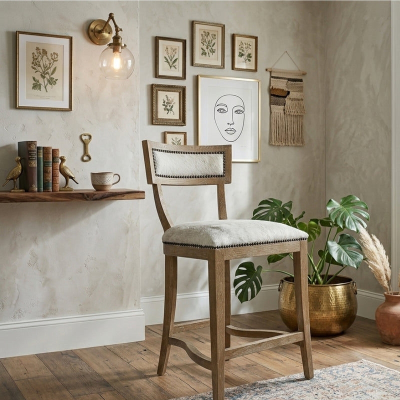 Carvell Cowhide Bar Stool by Zentique featuring a stylish accent chair design with black and white cowhide upholstery and wooden legs.