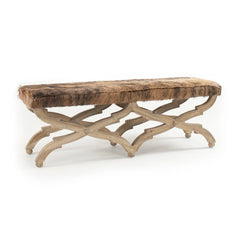 Cow hide bench with wooden legs by Zentique, featuring a natural cowhide seat and sturdy design.