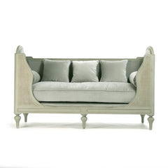 Light green outdoor Winni Daybed by Zentique with plush cushions and a sturdy wooden frame, perfect for relaxing outdoors.