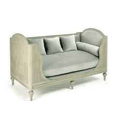 Light green outdoor Winni Daybed by Zentique with plush cushions and wooden frame for comfortable outdoor lounging.