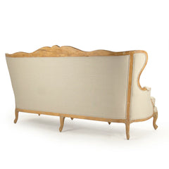 Eloy sofa by Zentique featuring plush upholstery, wooden legs, and elegant design in a cozy living room setting.