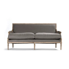 Louis sofa by Zentique featuring elegant tufted upholstery and wooden legs, showcasing a classic and sophisticated living room style.