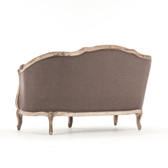 Maison Settee Limed Grey Oak by Zentique, a stylish grey upholstered sofa with wooden legs and a modern, elegant design.